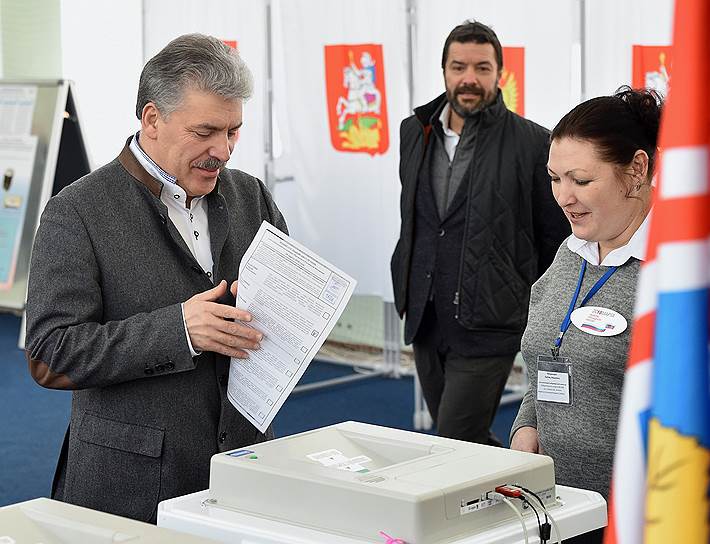 Кандидат в президенты РФ от КПРФ и народно-патриотических сил России Павел Грудинин (слева) и руководитель пресс-службы штаба кандидата в президенты России Павла Грудинина, депутат Госдумы Александр Ющенко (в центре) на избирательном участке в поселке Совхоза имени Ленина во время голосования