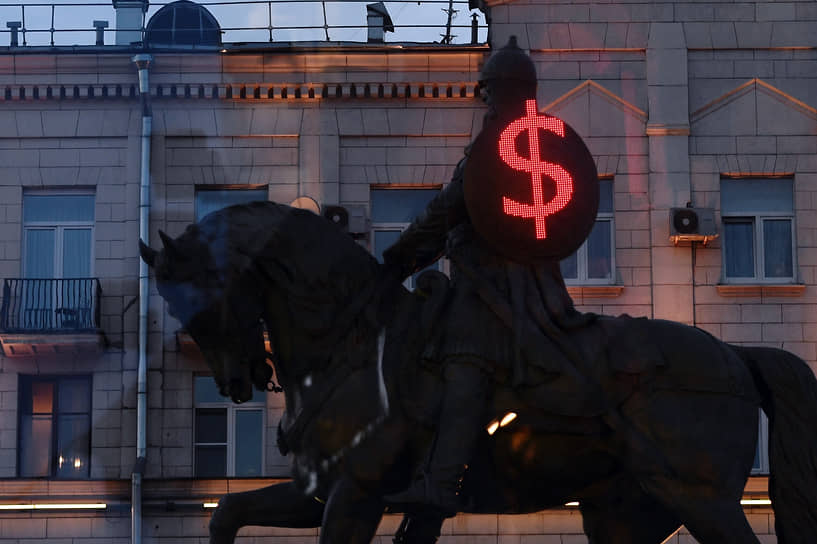 Москва, Россия. Памятник князю Юрию Долгорукому на фоне светового изображения знака доллара