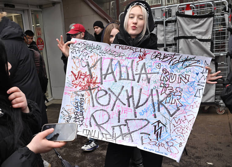Участница церемонии с плакатом  