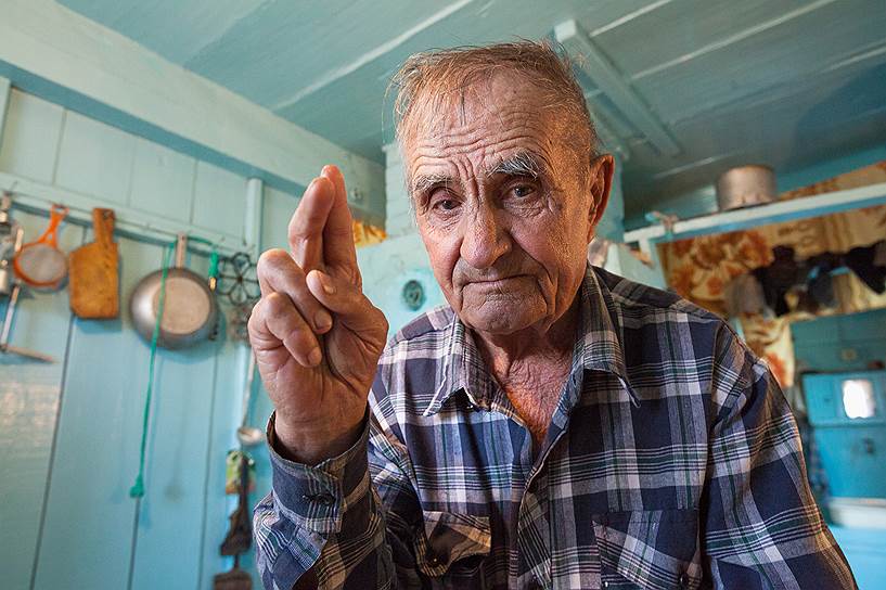 84-летний глава семьи Ульян Ефимович Болонев показывает, как правильно слагать персты
