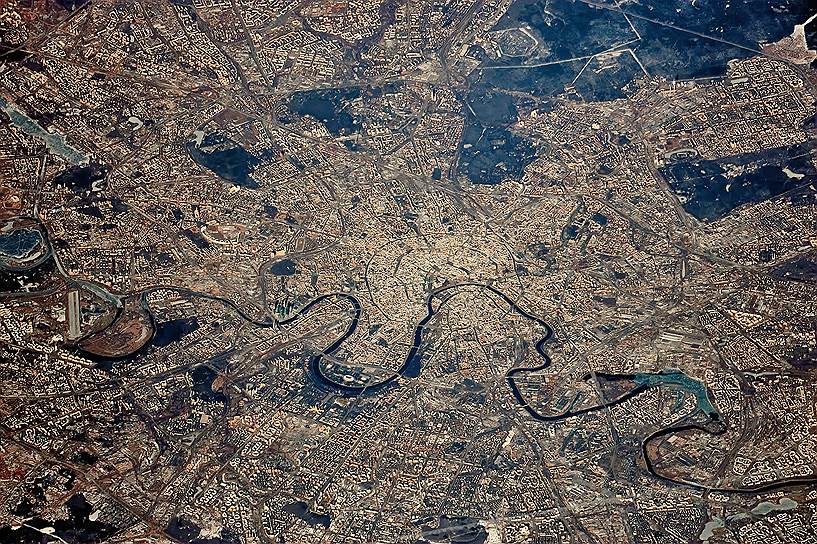 Москва. На вечернем снимке из космоса хорошо видно радиально-кольцевую планировку столицы России. Извилистой лентой пересекает ее Москва-река, четко просматривается сердце столицы — Кремль и «зеленые легкие» — национальный парк «Лосиный остров» и природно-исторический парк «Измайлово»