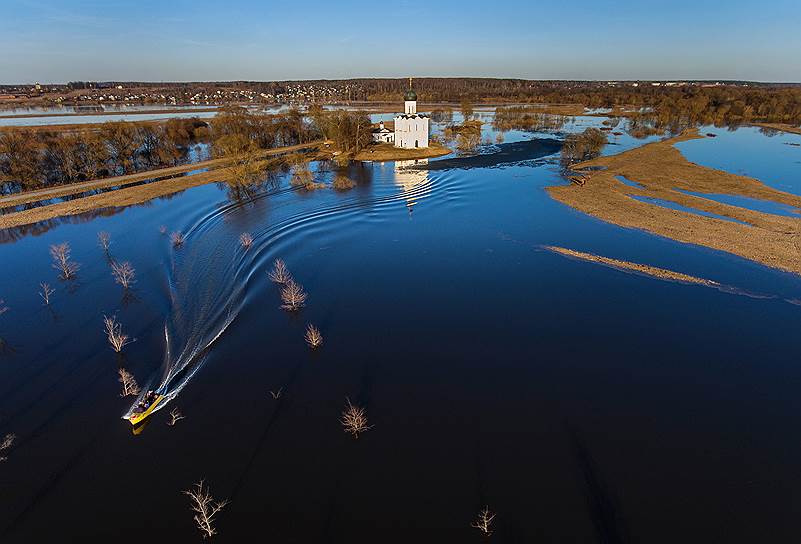 Луг вокруг церкви Покрова на Нерли залит водой. Местные жители катают туристов вокруг храма на лодках