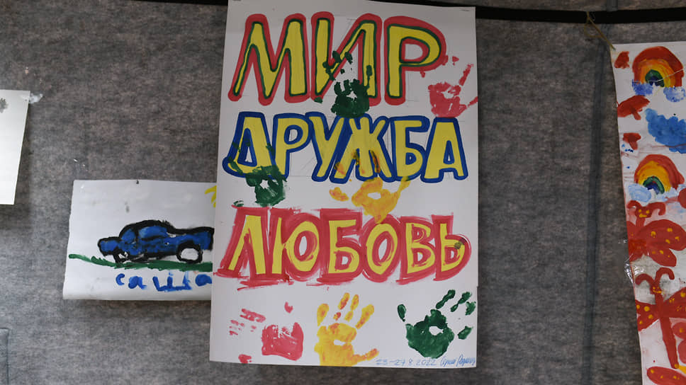 С потолка «комнаты досуга» свисают сложенные из бумаги фигурки и детские рисунки.
