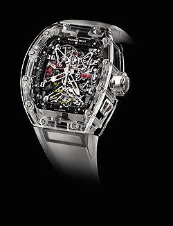 Richard Mille, RM056 Tourbillon Split Seconds Competition Chronograph Felipe Massa Sapphire — почти полностью прозрачная версия сложных спортивных часов, созданных в 2007 году в честь гонщика Scuderia Ferrari Фелипе Масса. В этой модели архитектурный стиль Ришара Милля выражен в полной мере: циферблат и "внутренности" выглядят практические бездонными  