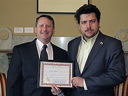 Депутат Леонид Волков (справа) съездил в Индиану и получил диплом из рук госсекретаря Чарли Уайта. Чарли Уайт (слева) съездил в соседний муниципалитет и получил требование об отставке 